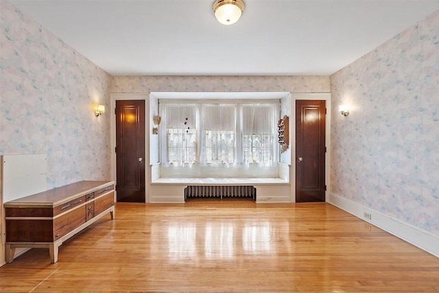 298 Highland St, Worcester, MA 01602 - spare room with radiator, wallpapered walls, and wood finished floors