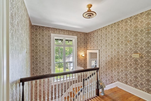 298 Highland St, Worcester, MA 01602 - hall featuring wood finished floors, ornamental molding, an upstairs landing, baseboards, and wallpapered walls