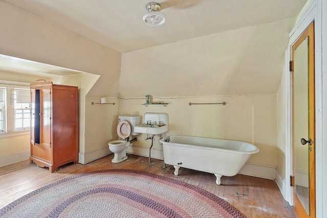 298 Highland St, Worcester, MA 01602 - full bath with hardwood / wood-style flooring, a soaking tub, toilet, and vaulted ceiling