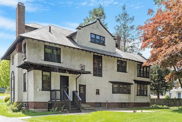 298 Highland St, Worcester, MA 01602 - view of front of house with stucco siding and a chimney