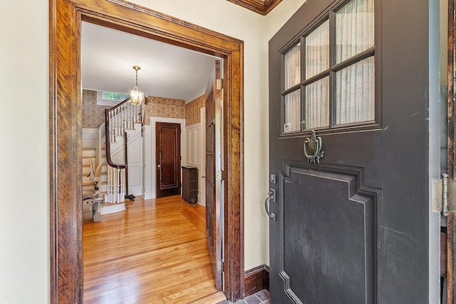298 Highland St, Worcester, MA 01602 - hall featuring stairway, ornamental molding, light wood-style floors, wallpapered walls, and baseboards