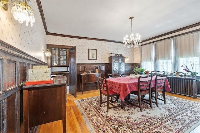 298 Highland St, Worcester, MA 01602 - dining room with a chandelier, crown molding, a wainscoted wall, wallpapered walls, and light wood finished floors