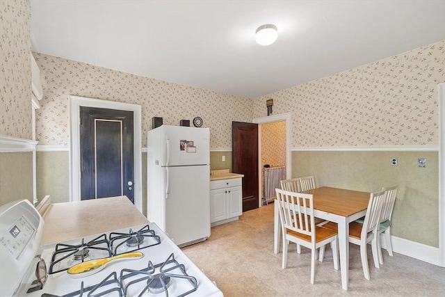 298 Highland St, Worcester, MA 01602 - kitchen with wallpapered walls, white appliances, wainscoting, light countertops, and light floors