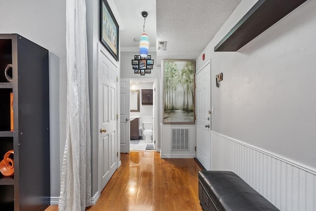 54 Forest St Unit 411, Medford, MA 02155 - hall with a textured ceiling and light wood-style flooring