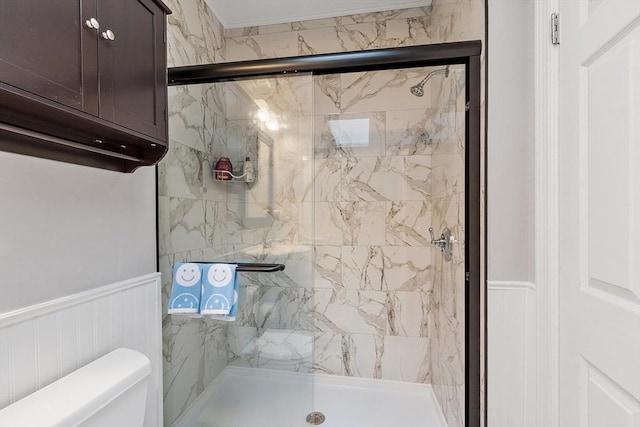 54 Forest St Unit 411, Medford, MA 02155 - bathroom with toilet, a marble finish shower, a wainscoted wall, and a decorative wall