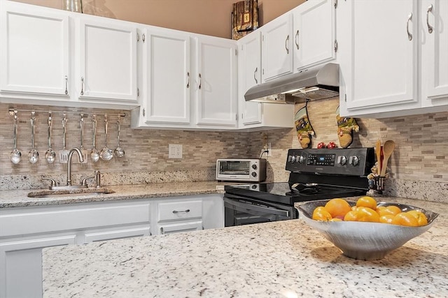 54 Forest St Unit 411, Medford, MA 02155 - kitchen featuring under cabinet range hood, black electric range, white cabinetry, and tasteful backsplash