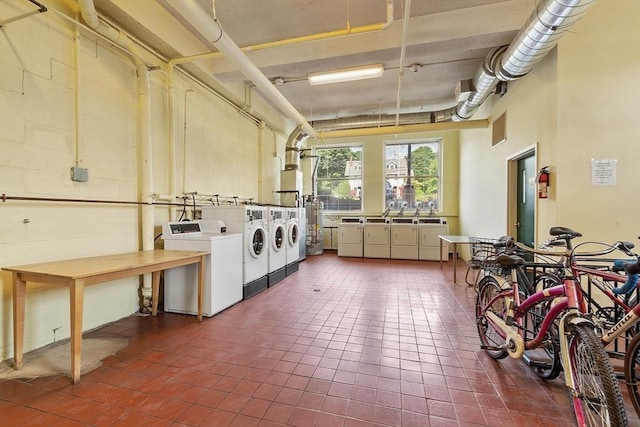 54 Forest St Unit 411, Medford, MA 02155 - community laundry featuring washer and dryer and dark tile patterned floors