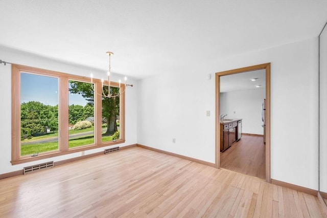 24 Skyridge Dr, Somers, CT 06071 - spare room featuring a sink, light wood-type flooring, baseboards, and a chandelier
