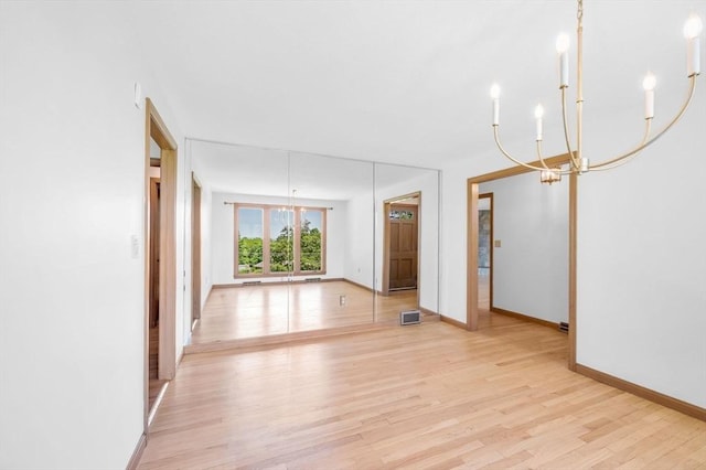24 Skyridge Dr, Somers, CT 06071 - empty room featuring a chandelier, light wood-type flooring, and baseboards
