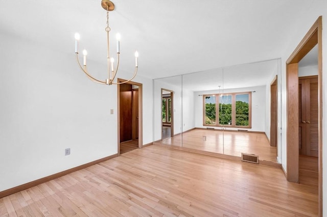24 Skyridge Dr, Somers, CT 06071 - empty room featuring light wood-style flooring, a chandelier, and baseboards