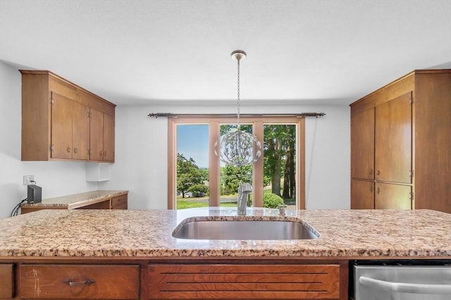 24 Skyridge Dr, Somers, CT 06071 - kitchen featuring stainless steel dishwasher, a sink, brown cabinetry, and pendant lighting