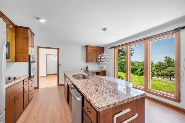 24 Skyridge Dr, Somers, CT 06071 - kitchen featuring a sink, stainless steel dishwasher, oven, light wood finished floors, and an island with sink