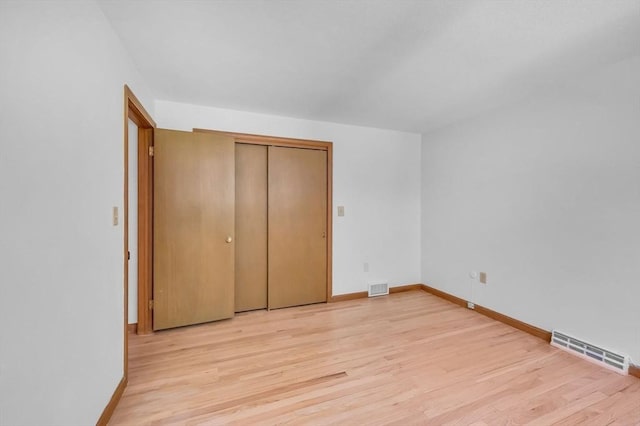 24 Skyridge Dr, Somers, CT 06071 - unfurnished bedroom featuring light wood-style floors, baseboards, and a closet