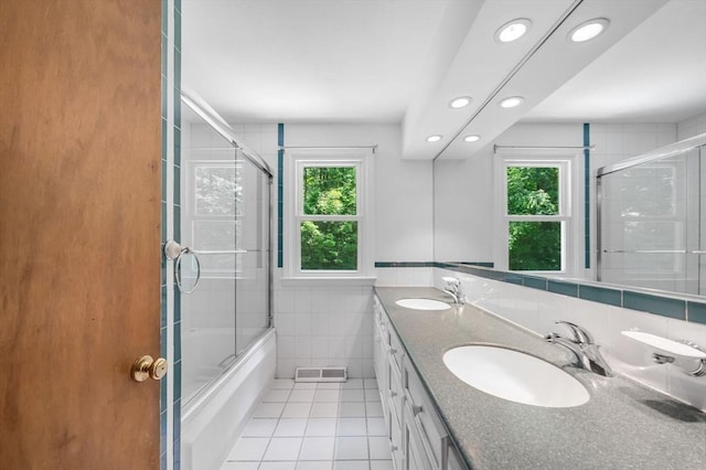 24 Skyridge Dr, Somers, CT 06071 - bathroom featuring tile walls, tile patterned flooring, recessed lighting, double vanity, and bath / shower combo with glass door