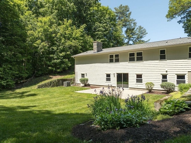 24 Skyridge Dr, Somers, CT 06071 - rear view of property with a patio, a lawn, central air condition unit, and a chimney