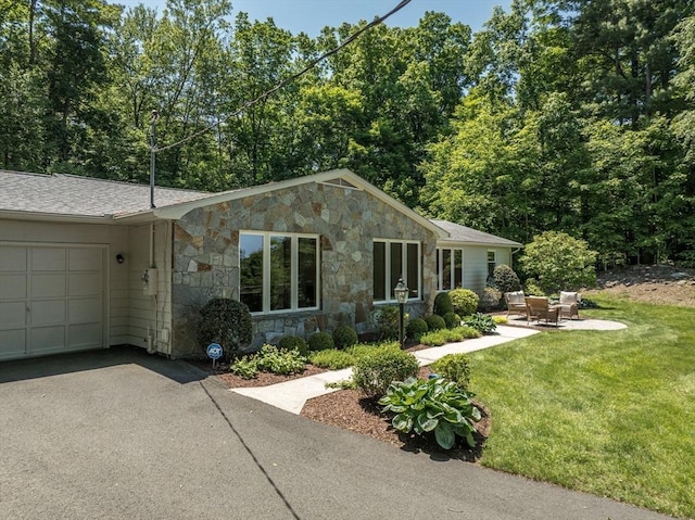 24 Skyridge Dr, Somers, CT 06071 - view of front facade featuring stone siding, an attached garage, a front lawn, and driveway