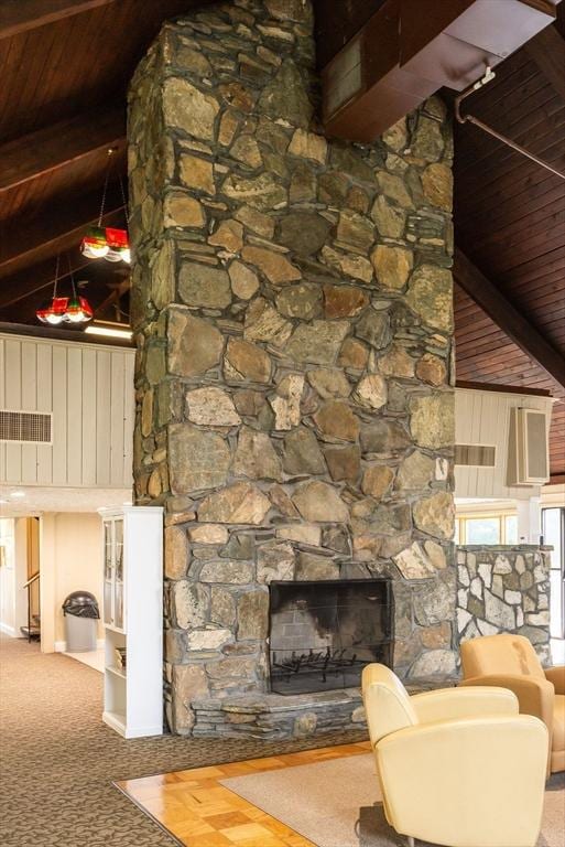 unfurnished living room with carpet floors, beamed ceiling, a fireplace, and a towering ceiling