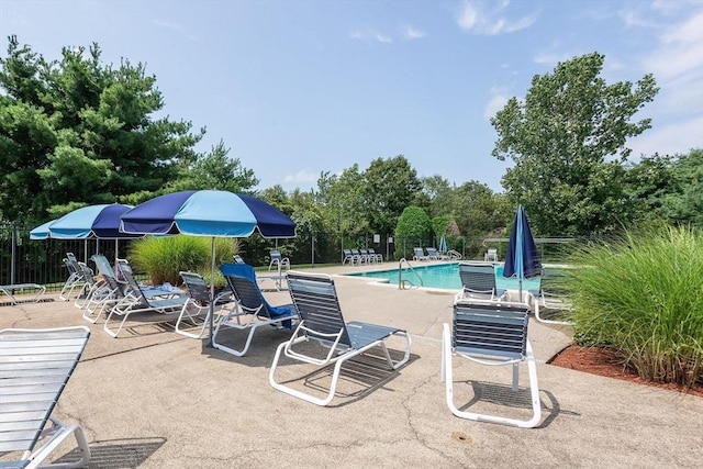 community pool featuring a patio area and fence