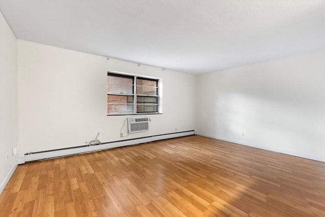 4925 Washington St Unit 304, Boston, MA 02132 - empty room featuring a baseboard heating unit, light wood-type flooring, and a wall unit AC