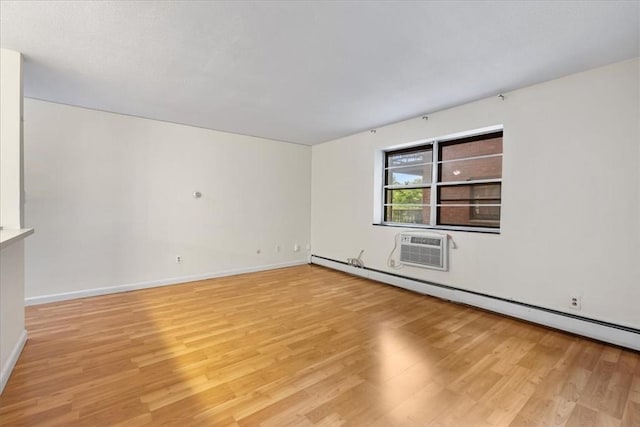 4925 Washington St Unit 304, Boston, MA 02132 - empty room featuring light wood finished floors, a wall mounted AC, and a baseboard radiator