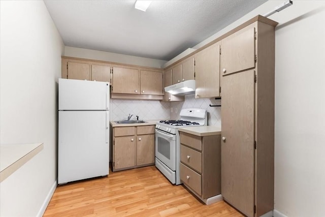 4925 Washington St Unit 304, Boston, MA 02132 - kitchen with white appliances, under cabinet range hood, light wood-style flooring, and light countertops