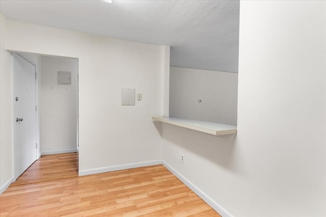 4925 Washington St Unit 304, Boston, MA 02132 - hallway featuring light wood-type flooring and a textured ceiling