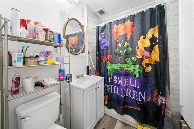 bathroom featuring vanity, toilet, and hardwood / wood-style flooring