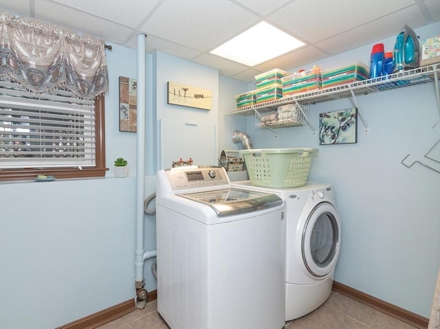 clothes washing area featuring independent washer and dryer and light tile patterned floors