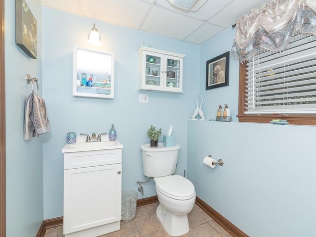 bathroom featuring vanity, tile patterned flooring, a paneled ceiling, and toilet