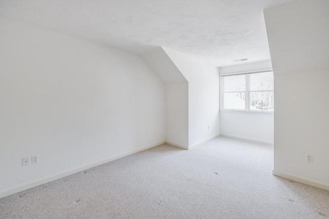 bonus room featuring carpet floors, baseboards, vaulted ceiling, and visible vents