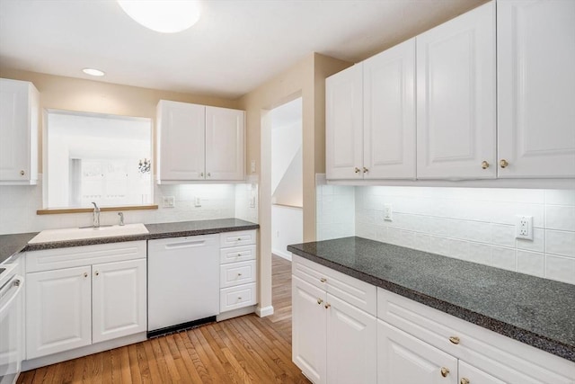 kitchen with light wood-type flooring, white dishwasher, white cabinets, and tasteful backsplash