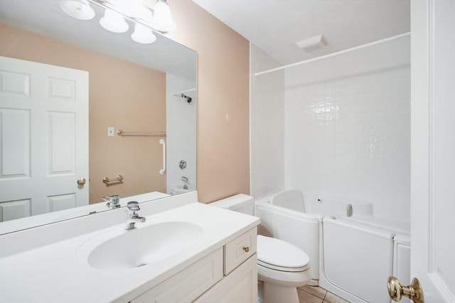 bathroom with vanity, tile patterned floors, toilet, and shower / washtub combination