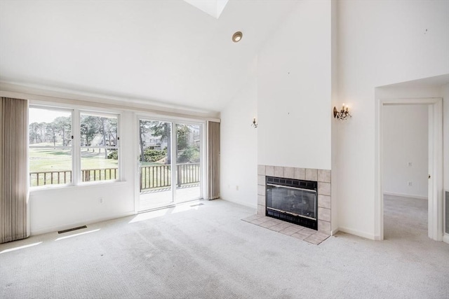 unfurnished living room featuring high vaulted ceiling, a fireplace, carpet floors, and visible vents