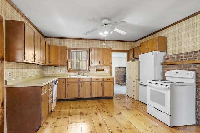 kitchen featuring light wood-type flooring, light countertops, a ceiling fan, and white appliances