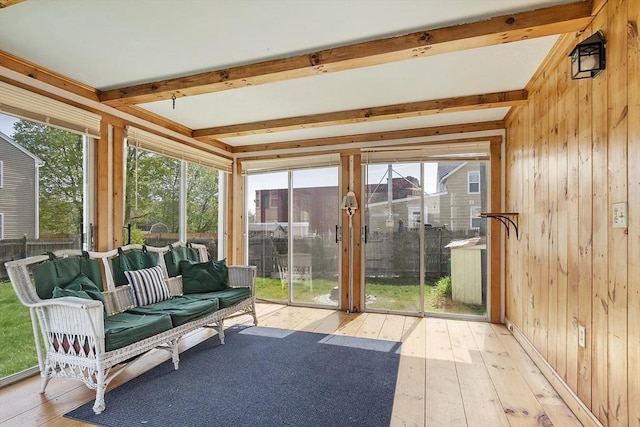 sunroom featuring beam ceiling