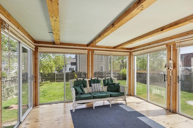 sunroom featuring a healthy amount of sunlight and beamed ceiling