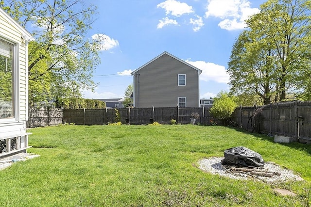 view of yard featuring a fire pit and a fenced backyard