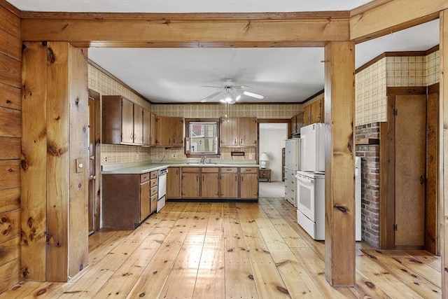 kitchen with ceiling fan, white electric range, light countertops, a sink, and light wood finished floors