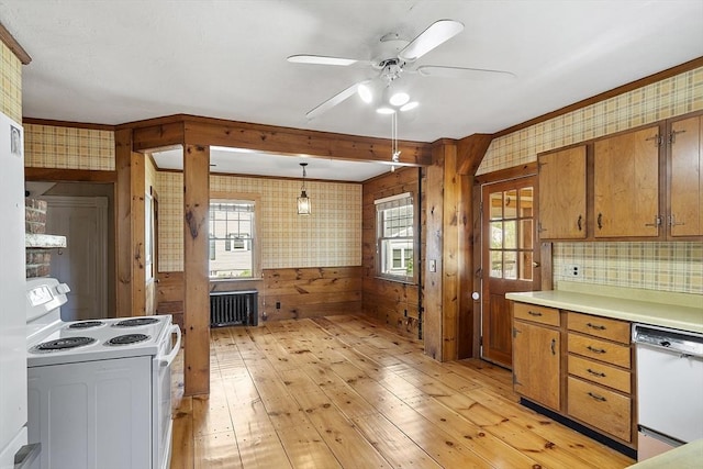kitchen featuring a healthy amount of sunlight, ceiling fan, wallpapered walls, light wood finished floors, and white appliances