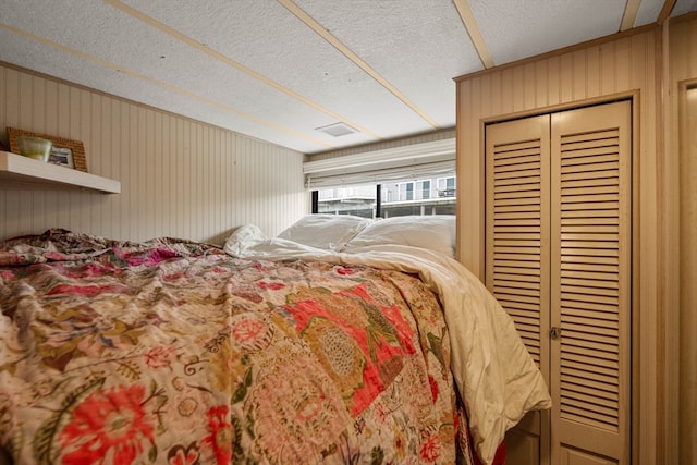 bedroom featuring wooden walls