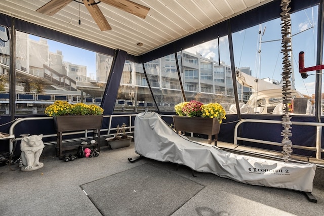 view of patio featuring ceiling fan and a balcony