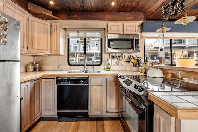 kitchen with wood ceiling, tile counters, light hardwood / wood-style flooring, sink, and black appliances