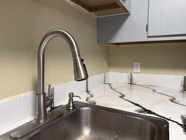 1186 Worcester Rd Unit 1221, Framingham, MA 01702 - kitchen view of a sink, white cabinetry, and light stone counters
