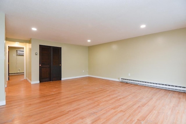 1186 Worcester Rd Unit 1221, Framingham, MA 01702 - empty room featuring baseboard heating, a baseboard radiator, light wood finished floors, recessed lighting, and baseboards