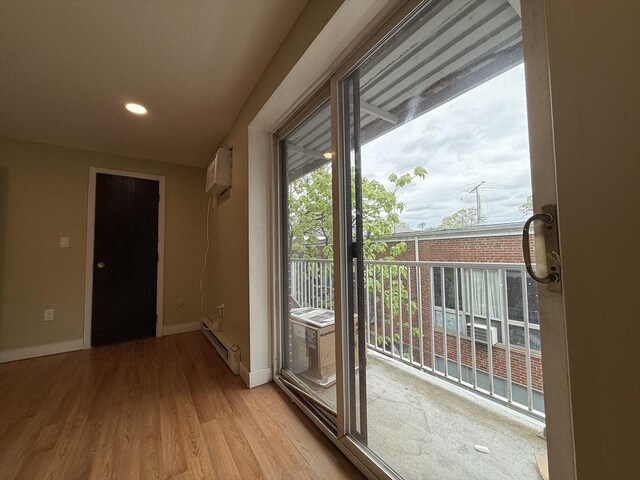 1186 Worcester Rd Unit 1221, Framingham, MA 01702 - entryway featuring baseboards, light wood-style flooring, baseboard heating, a wall mounted AC, and recessed lighting