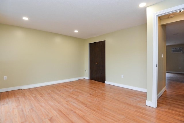 1186 Worcester Rd Unit 1221, Framingham, MA 01702 - spare room with light wood finished floors, baseboards, a wall mounted AC, and recessed lighting