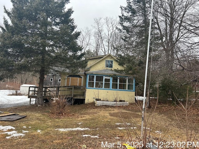 back of house with a deck and a sunroom