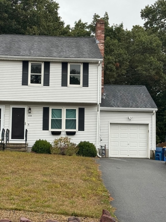 view of front facade with a front yard and a garage