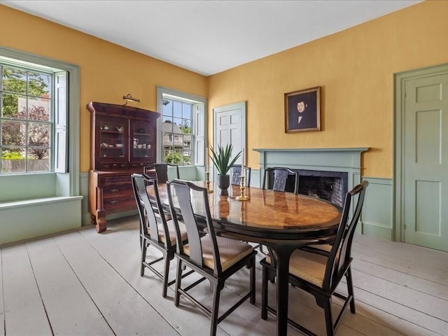 dining room featuring light wood-type flooring and a wealth of natural light