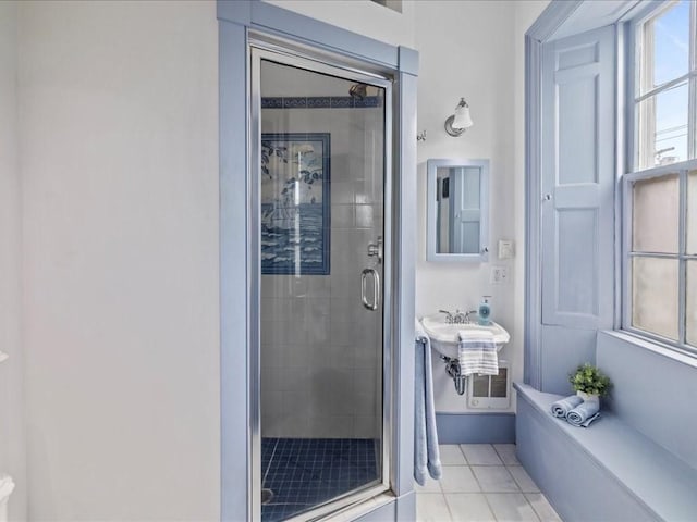 bathroom with tile patterned flooring and a shower with door